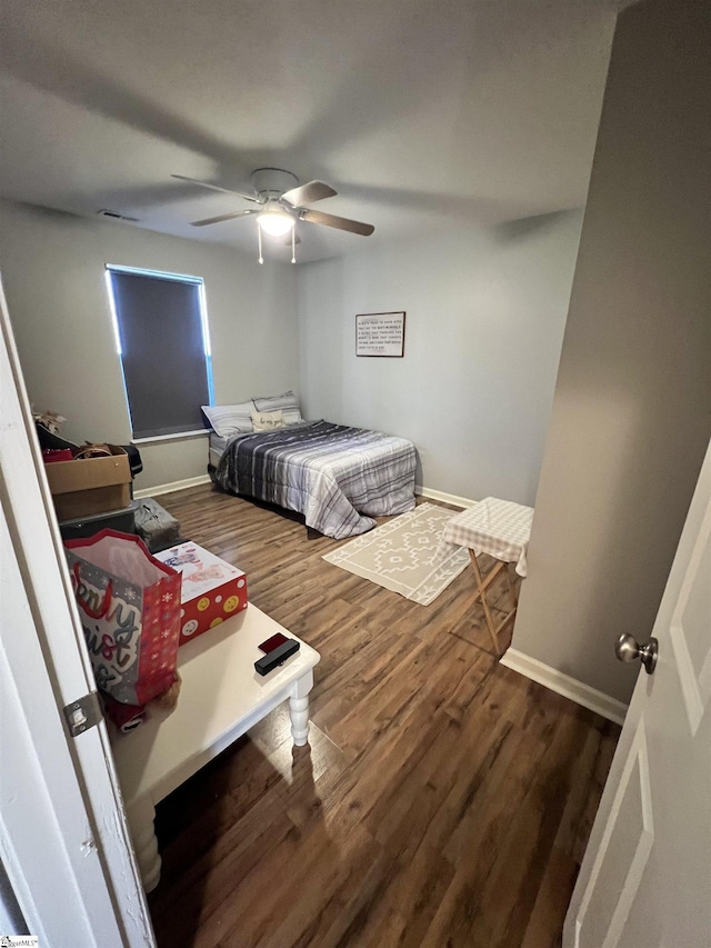 bedroom featuring ceiling fan and dark hardwood / wood-style flooring