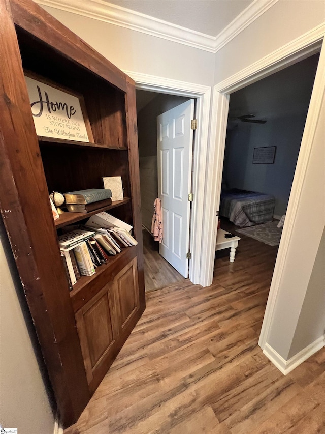 hall with hardwood / wood-style floors and crown molding