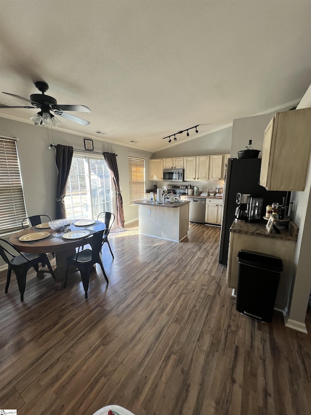 dining space with ceiling fan, dark hardwood / wood-style flooring, lofted ceiling, and ornamental molding