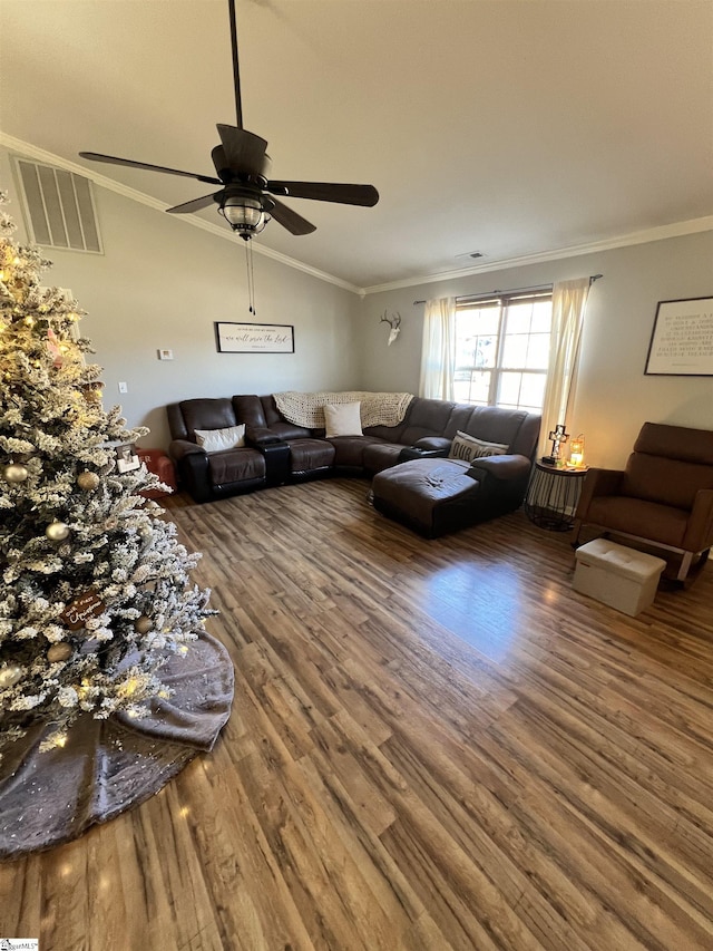 living room featuring wood-type flooring, vaulted ceiling, and ornamental molding