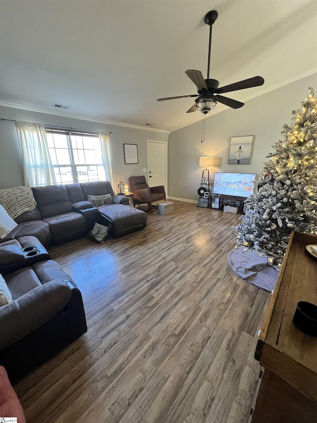 living room featuring ceiling fan, wood-type flooring, and ornamental molding