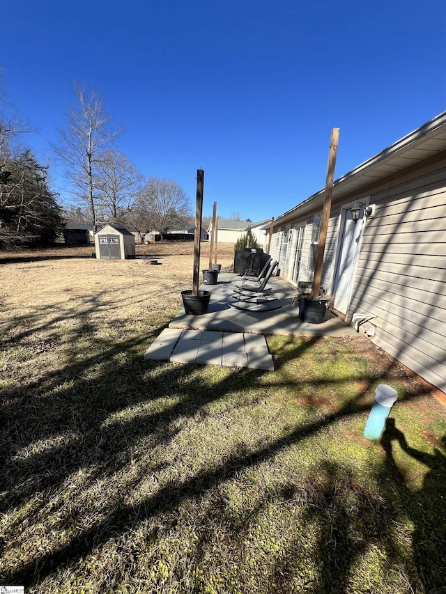 view of yard with a patio area and a shed