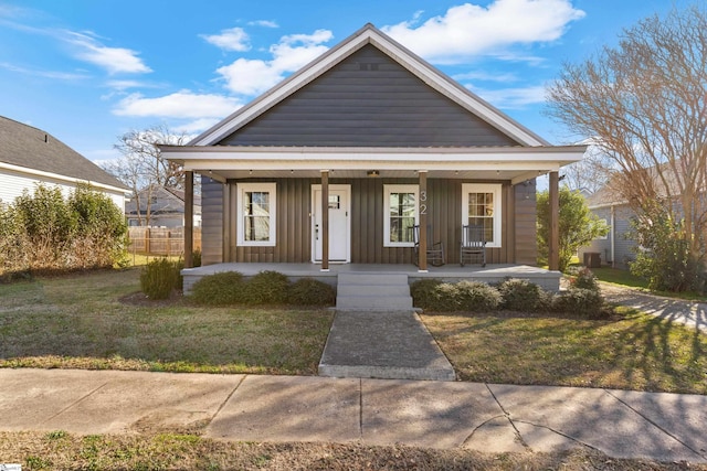 bungalow-style home featuring a front lawn and covered porch