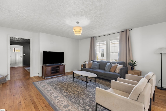 living room featuring hardwood / wood-style flooring and a textured ceiling