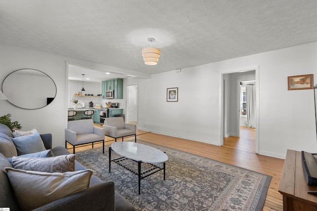 living room featuring light hardwood / wood-style floors and a textured ceiling