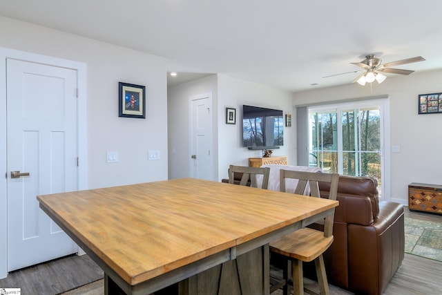 dining room with light wood-type flooring and ceiling fan