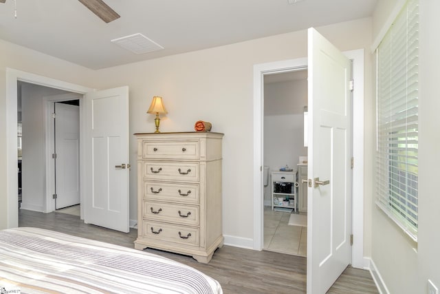 bedroom with wood-type flooring and ceiling fan