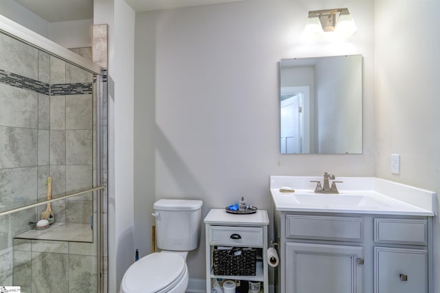 bathroom featuring walk in shower, vanity, and toilet