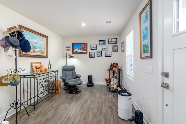 sitting room with wood-type flooring