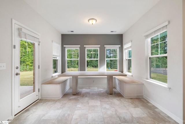 unfurnished sunroom featuring a wealth of natural light