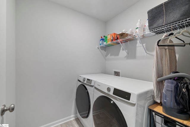 clothes washing area with washer and dryer