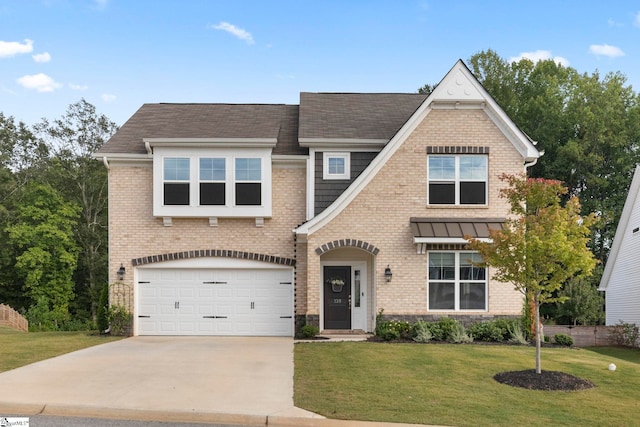 view of front of house with a garage and a front lawn