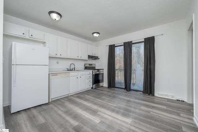 kitchen featuring white cabinetry, sink, a textured ceiling, white appliances, and light wood-type flooring