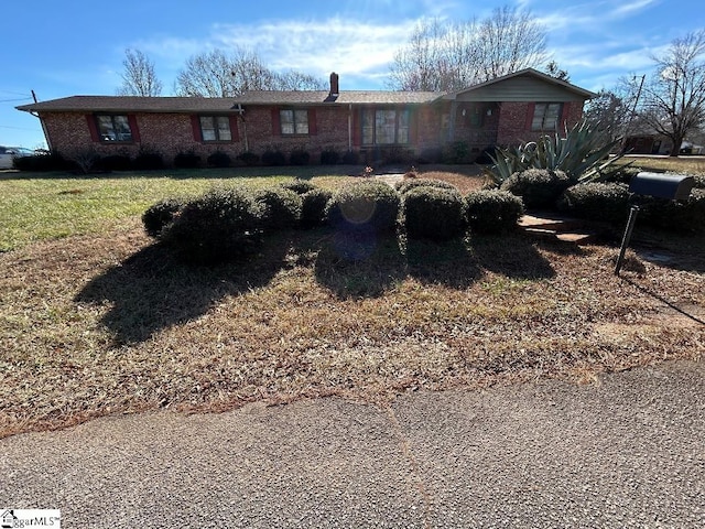 ranch-style home with a front lawn