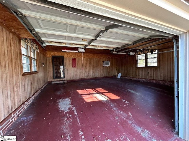 garage with wood walls and a garage door opener