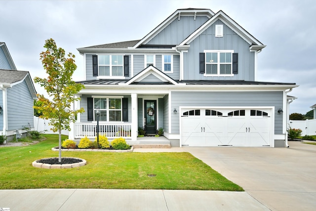 craftsman inspired home with a front lawn, covered porch, and a garage