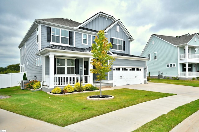 craftsman house with cooling unit, covered porch, a front yard, and a garage