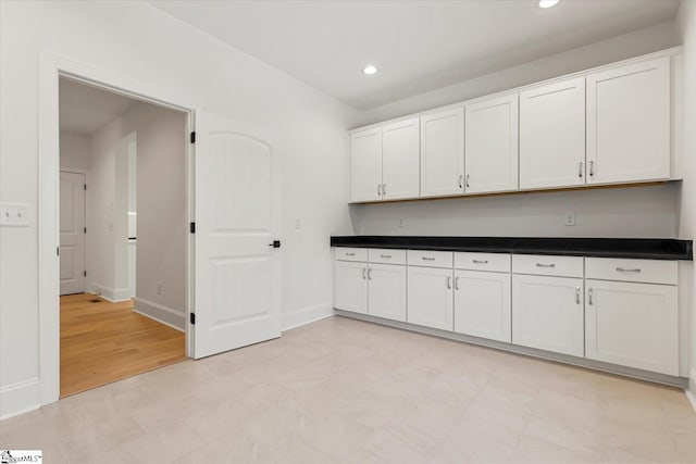 interior space with white cabinets and light hardwood / wood-style floors