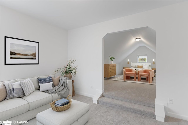 living room with light colored carpet and lofted ceiling