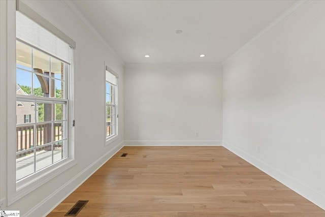 empty room with light hardwood / wood-style flooring and ornamental molding