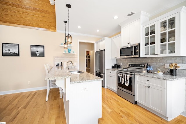 kitchen featuring hanging light fixtures, sink, tasteful backsplash, appliances with stainless steel finishes, and white cabinets