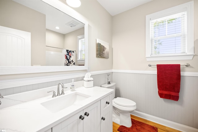 bathroom featuring toilet, vanity, hardwood / wood-style floors, and a shower with curtain