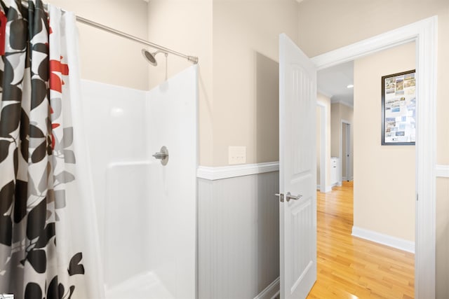 bathroom with walk in shower and wood-type flooring