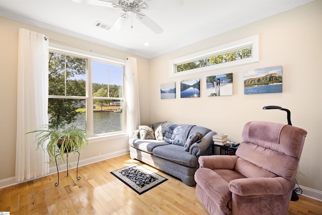 sitting room with ceiling fan, light hardwood / wood-style floors, crown molding, and a healthy amount of sunlight