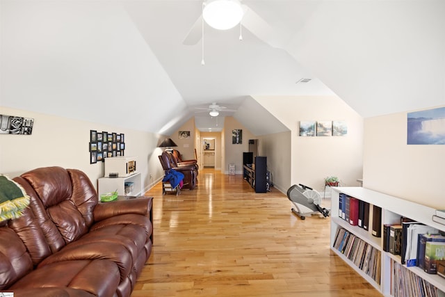 living room with ceiling fan, vaulted ceiling, and light hardwood / wood-style floors