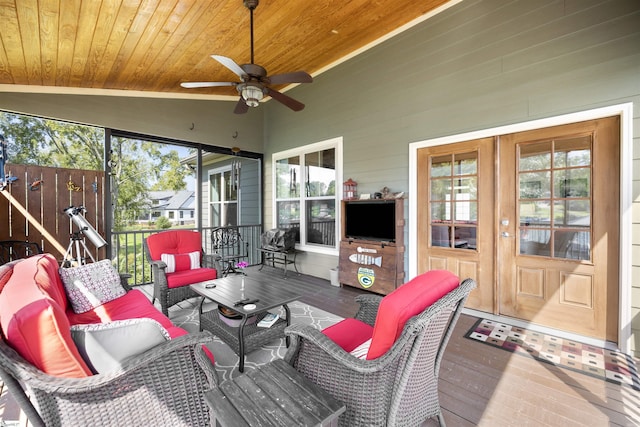 sunroom / solarium featuring lofted ceiling, wooden ceiling, and ceiling fan