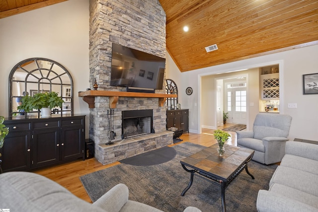 living room featuring high vaulted ceiling, light hardwood / wood-style flooring, wooden ceiling, and a fireplace