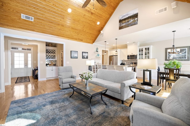 living room featuring high vaulted ceiling, light hardwood / wood-style flooring, a chandelier, and wooden ceiling