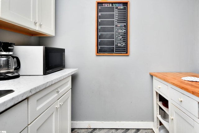 kitchen with white cabinets and light stone countertops