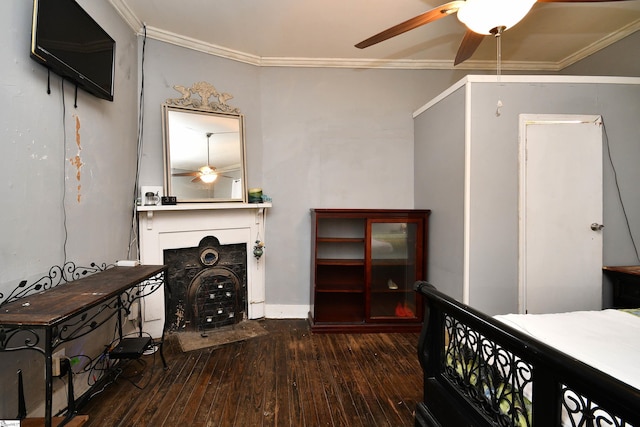 bedroom featuring dark hardwood / wood-style floors, ceiling fan, and crown molding