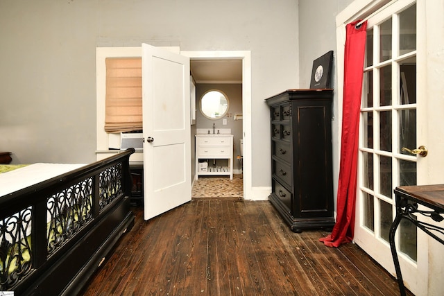 bedroom featuring dark hardwood / wood-style floors, ornamental molding, and sink