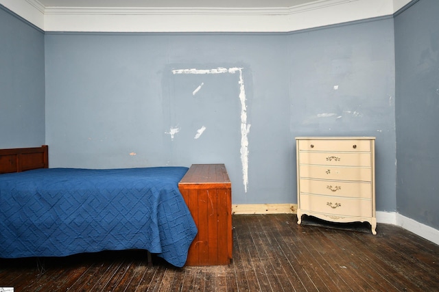 bedroom featuring wood-type flooring and ornamental molding