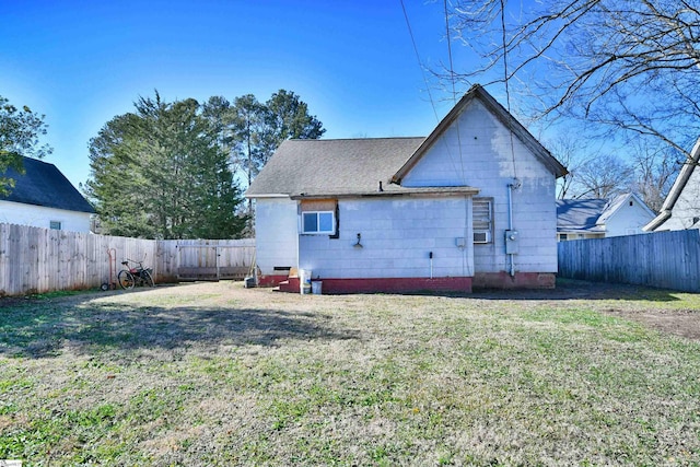 rear view of house with a yard