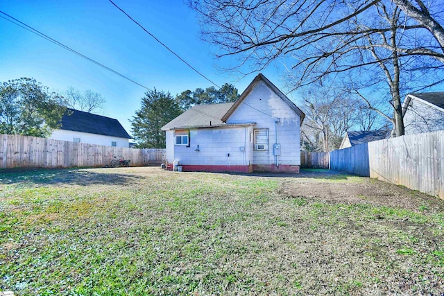 back of property featuring a lawn