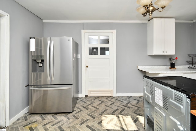 kitchen featuring white cabinets, a notable chandelier, stainless steel fridge, and crown molding