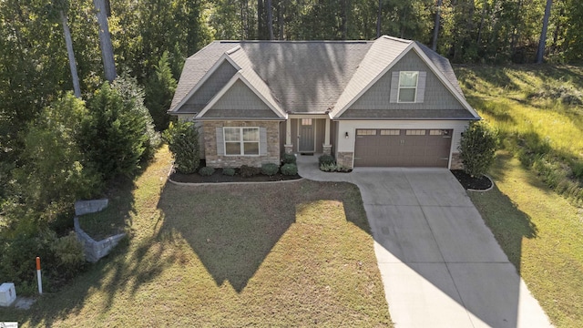 craftsman inspired home featuring a garage and a front lawn