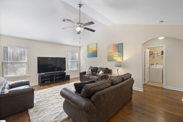 living room with ceiling fan, washer / dryer, lofted ceiling, and dark wood-type flooring