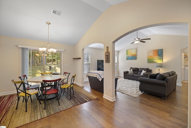 dining room featuring ceiling fan with notable chandelier, dark hardwood / wood-style floors, and lofted ceiling