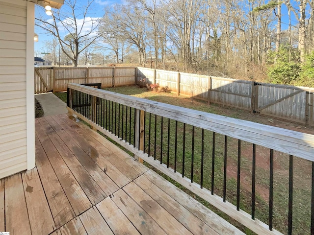 wooden deck featuring a yard