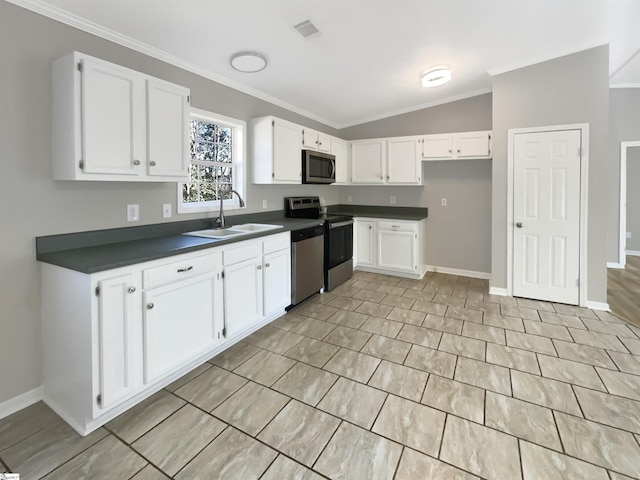 kitchen with white cabinets, sink, stainless steel appliances, and vaulted ceiling