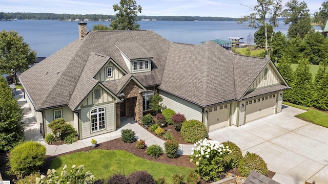 view of front of property featuring a water view and a garage