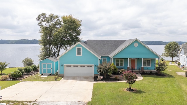 view of front of property with a garage, a porch, a water view, and a front lawn