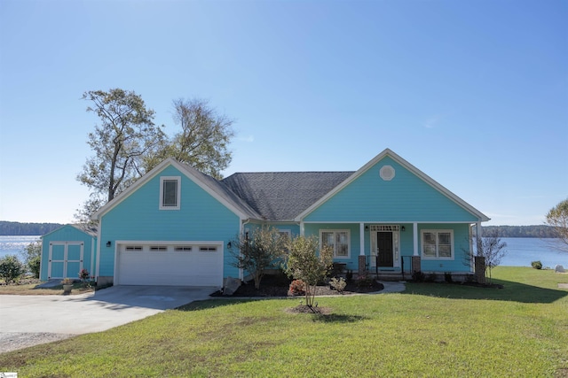 view of front of home featuring covered porch, a water view, a front lawn, and a storage shed