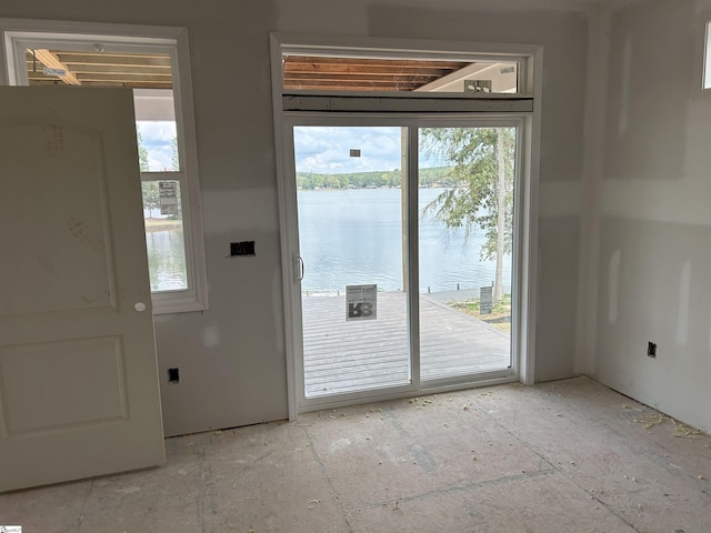 doorway to outside featuring a water view and a healthy amount of sunlight