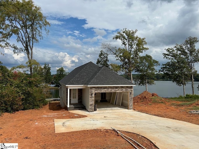 view of front of property with a water view and a carport