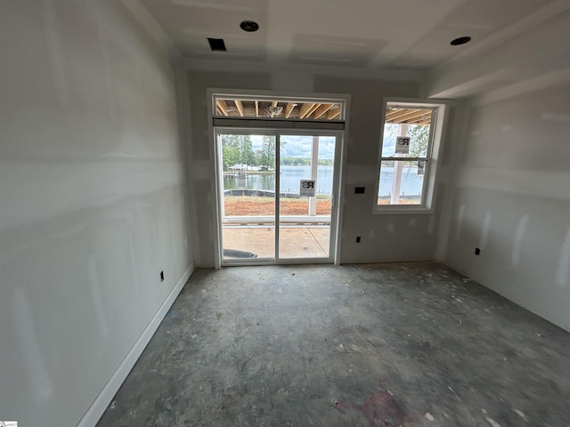 spare room featuring a water view